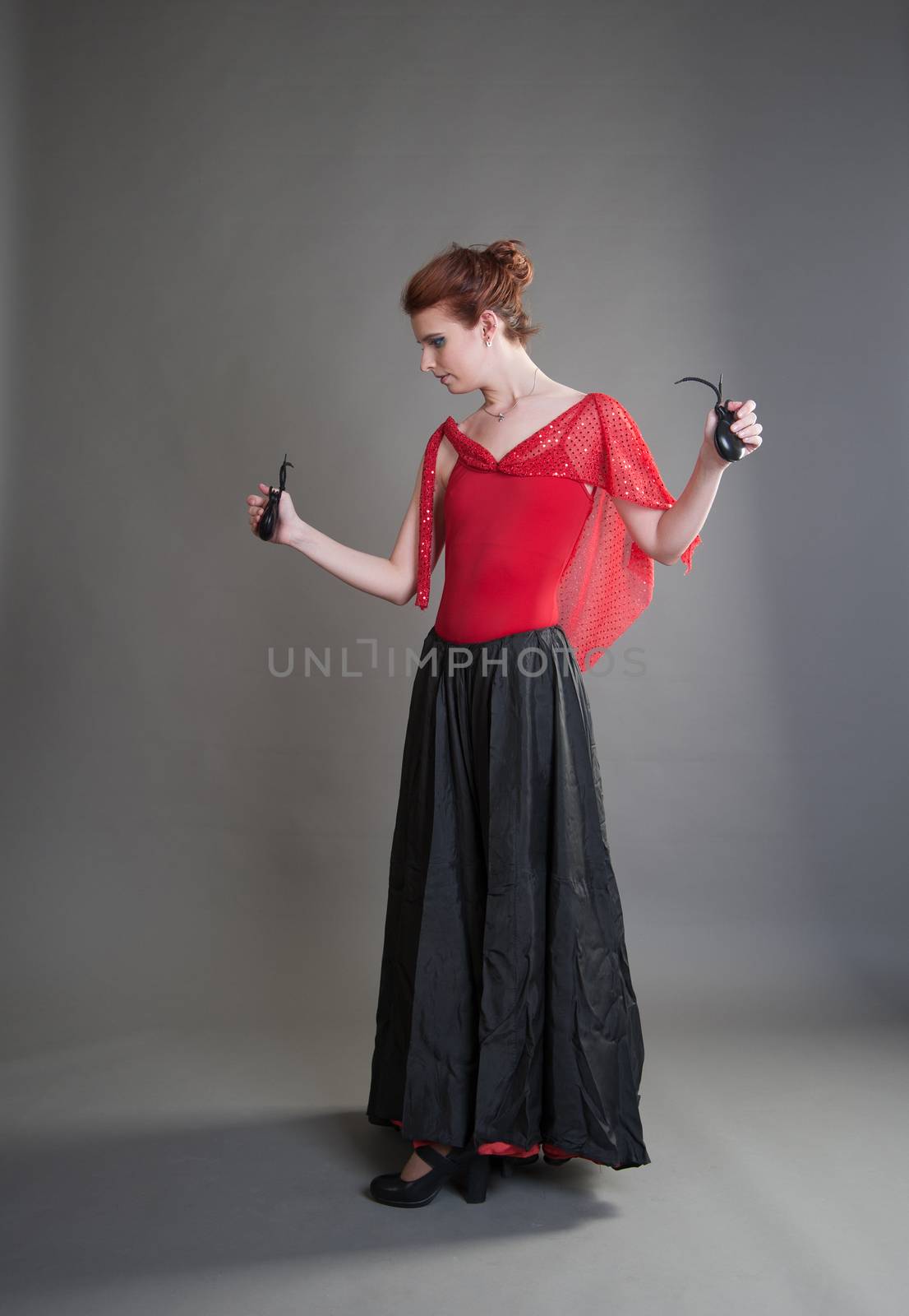 flamenco dancer swinging skirt on a grey background