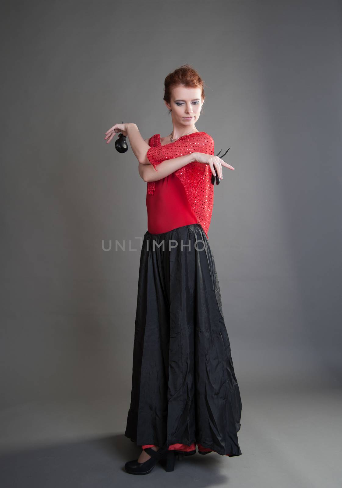 flamenco dancer swinging skirt on a grey background