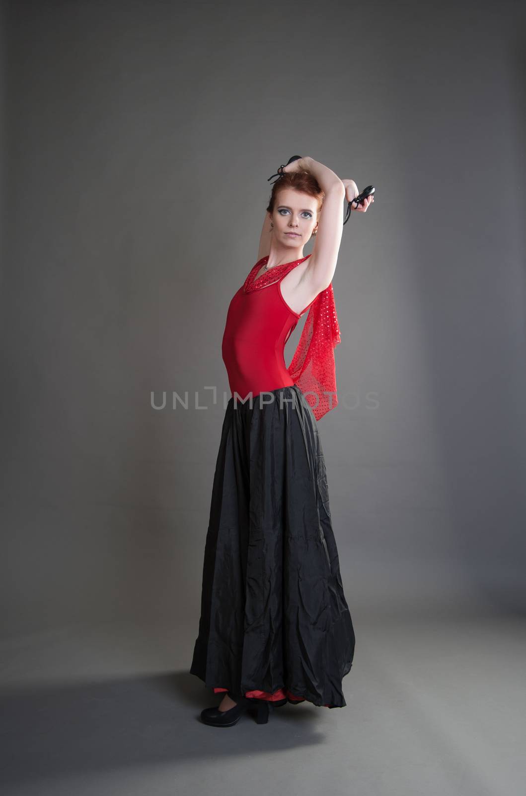 flamenco dancer swinging skirt on a grey background