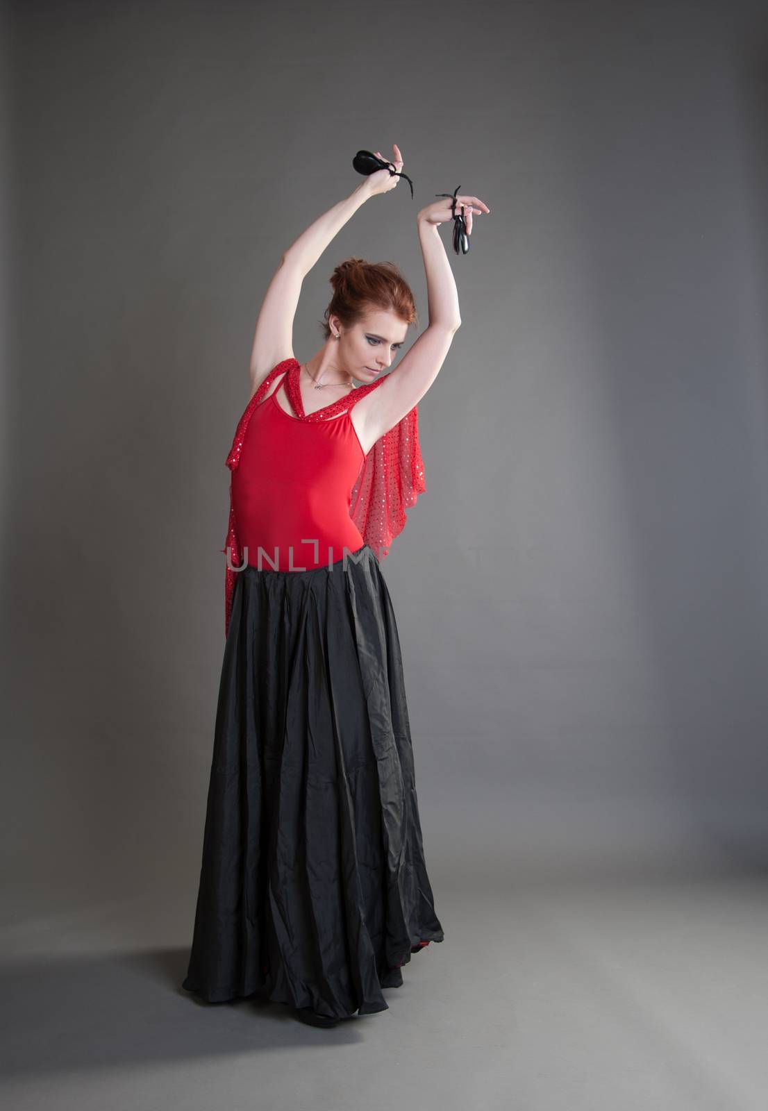 flamenco dancer swinging skirt on a grey background