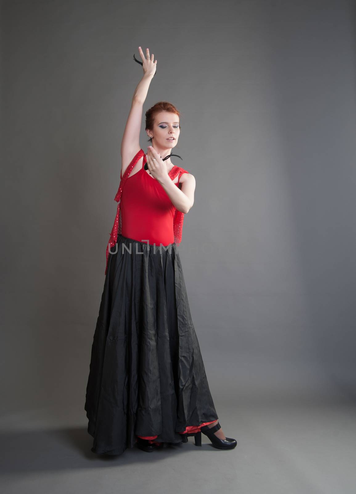 flamenco dancer swinging skirt on a grey background