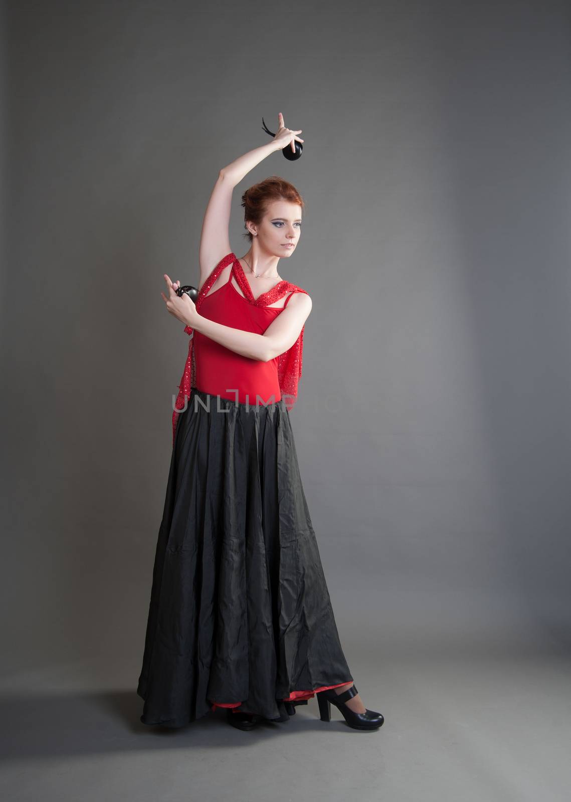 flamenco dancer swinging skirt on a grey background