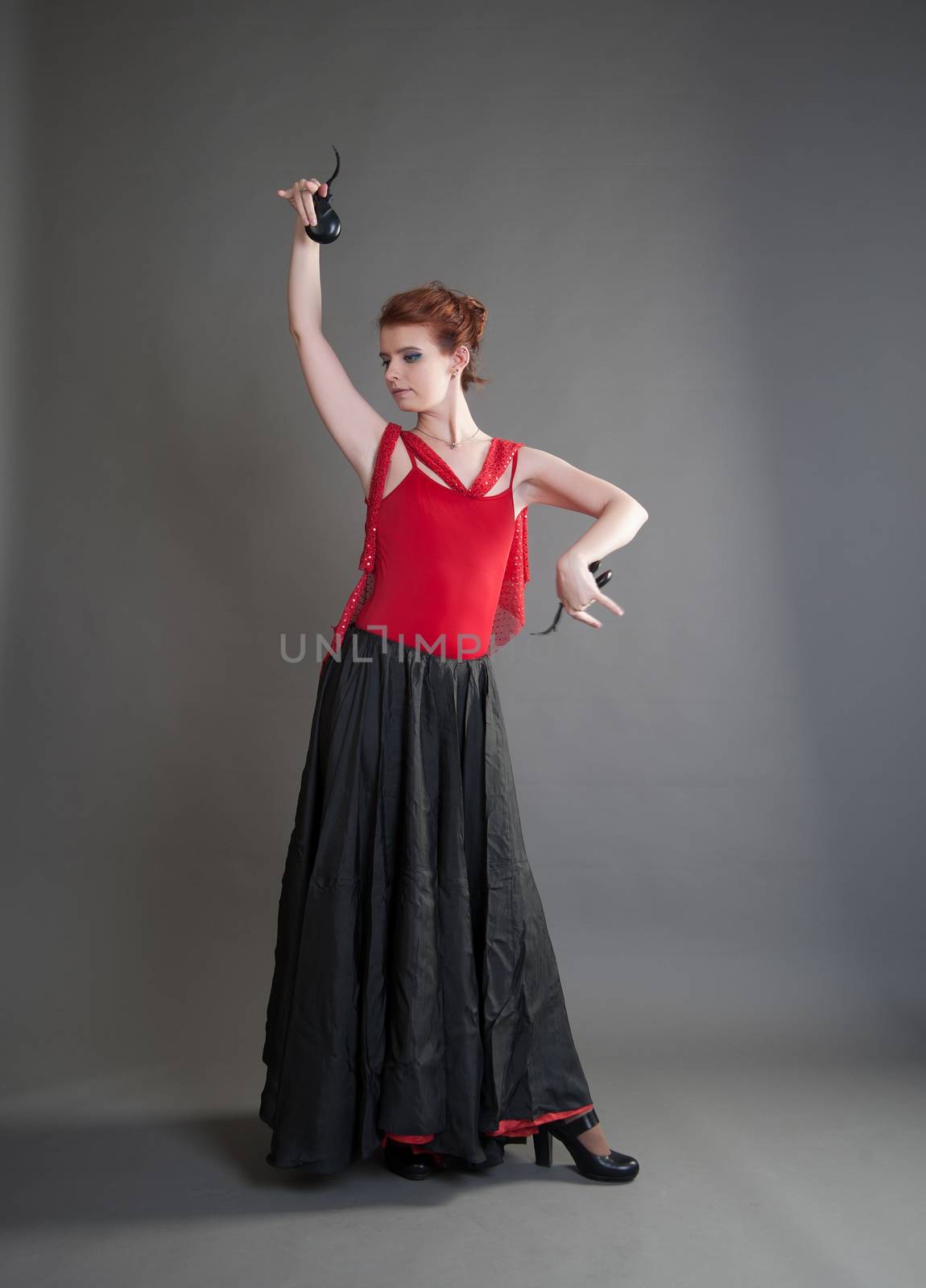 flamenco dancer swinging skirt on a grey background