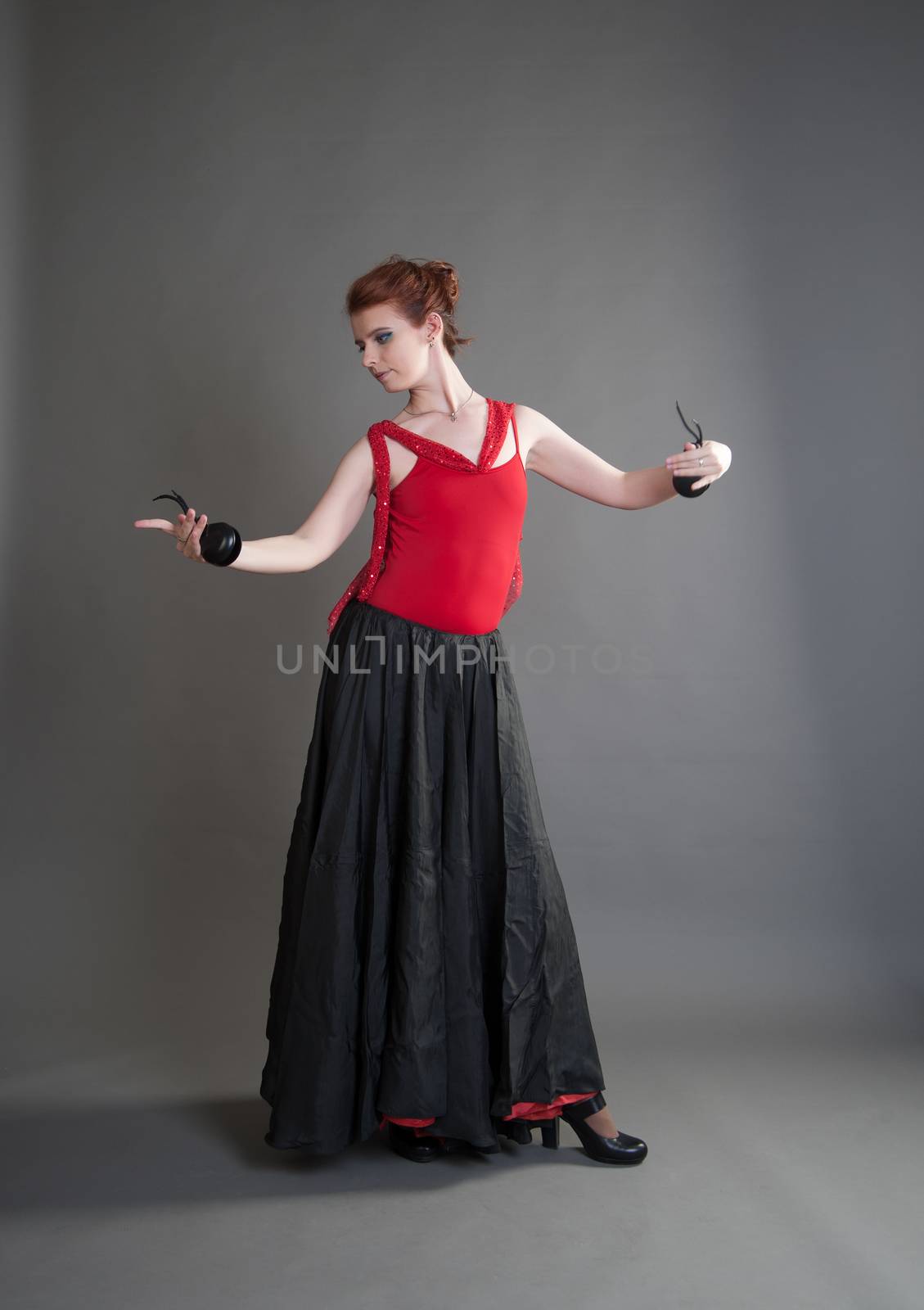 flamenco dancer swinging skirt on a grey background