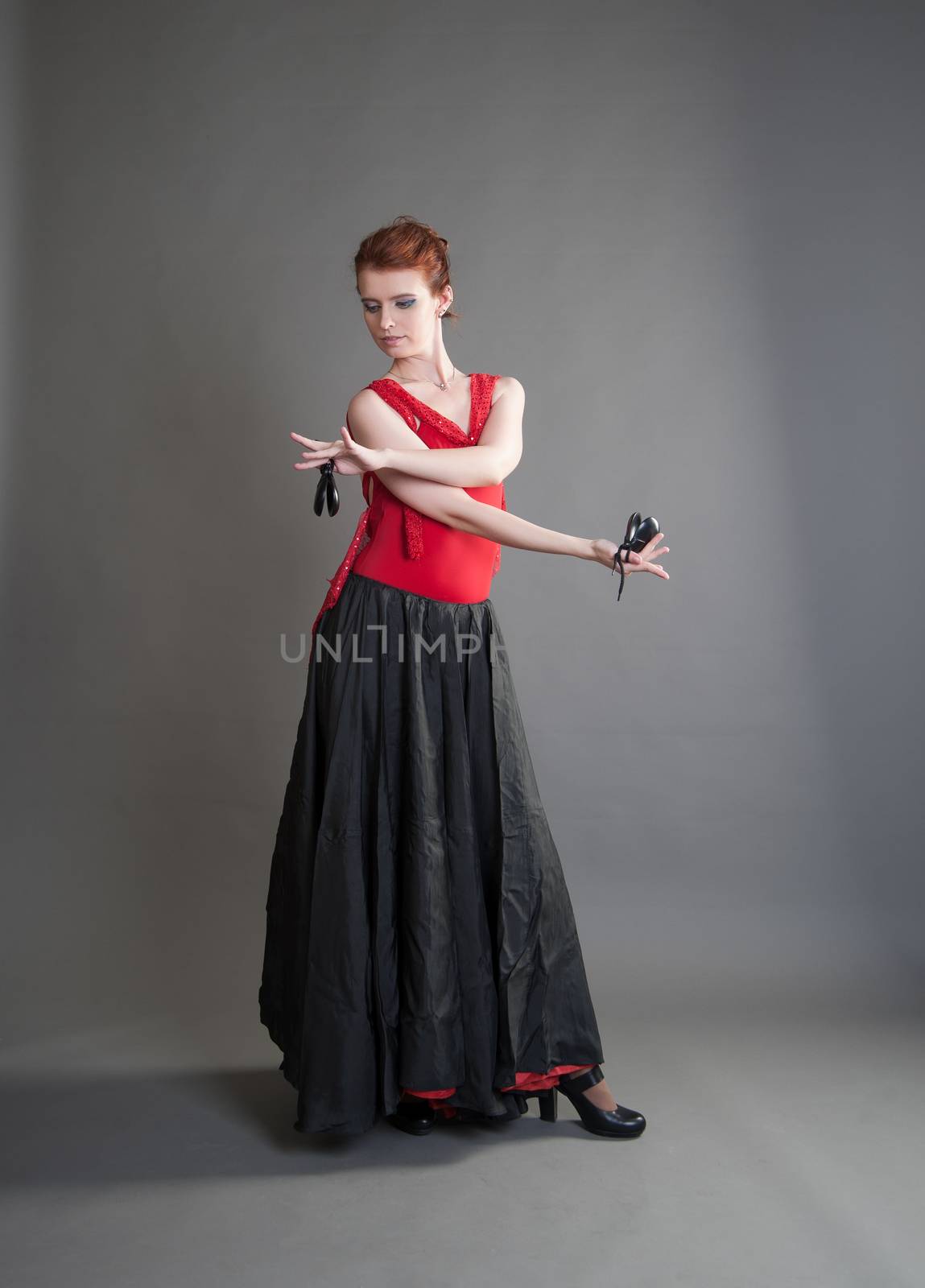 flamenco dancer swinging skirt on a grey background