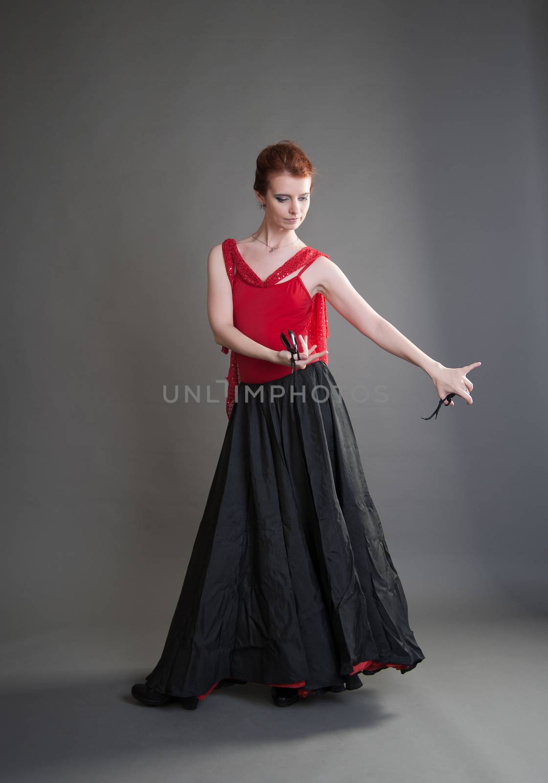 flamenco dancer swinging skirt on a grey background