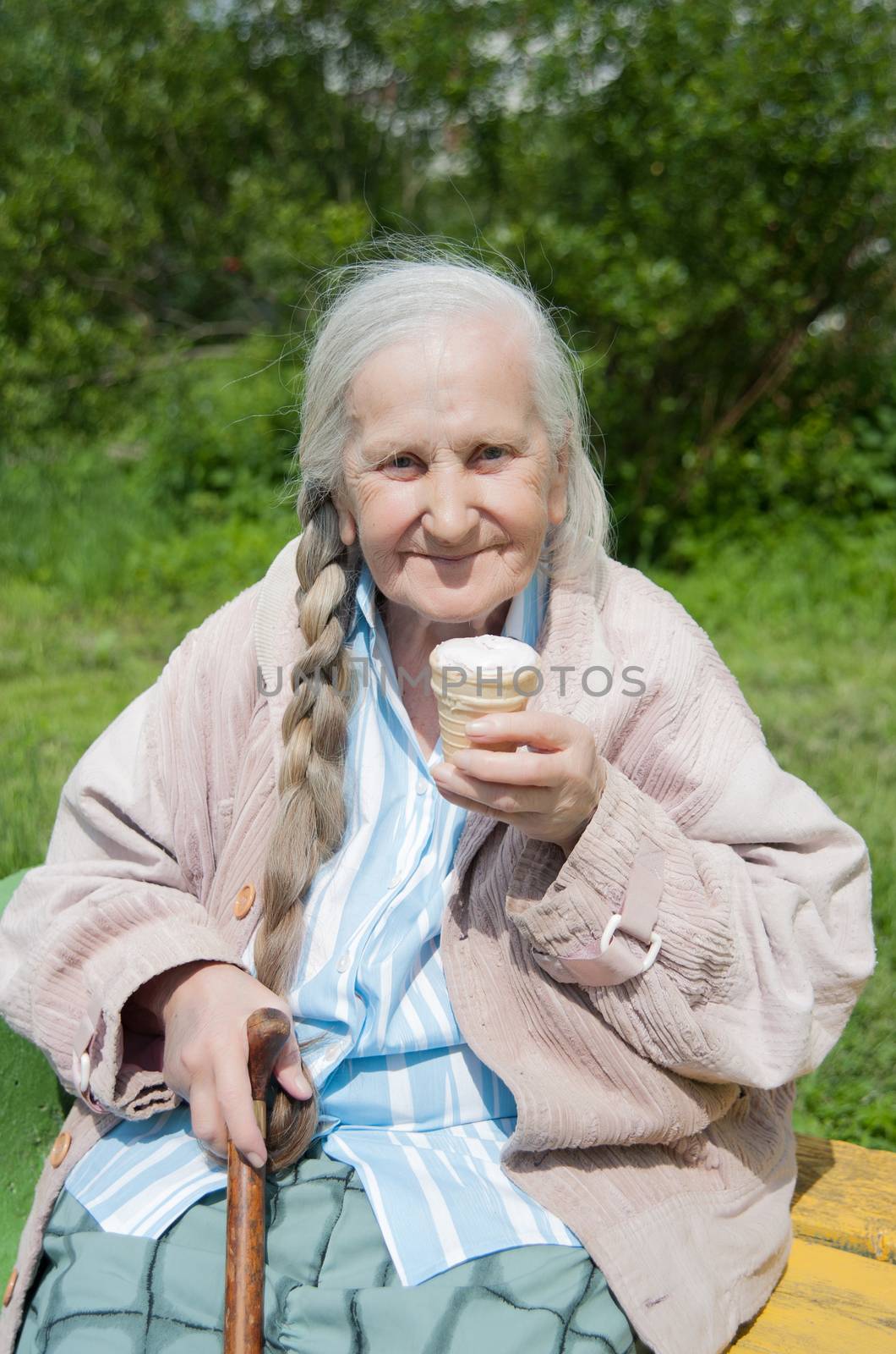 old grandmother to eat ice cream in the summer in the Park