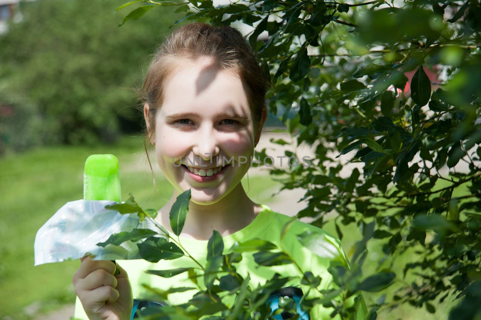 joyful girl eating ice cream in the summer in the Park