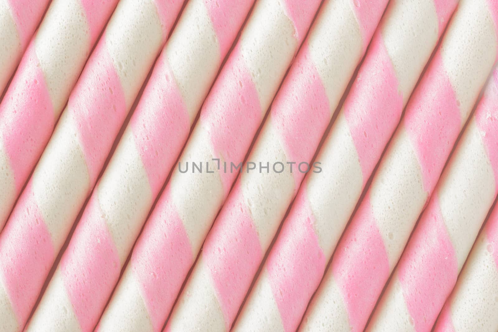 Closeup pink stripe wafer rolls Background .