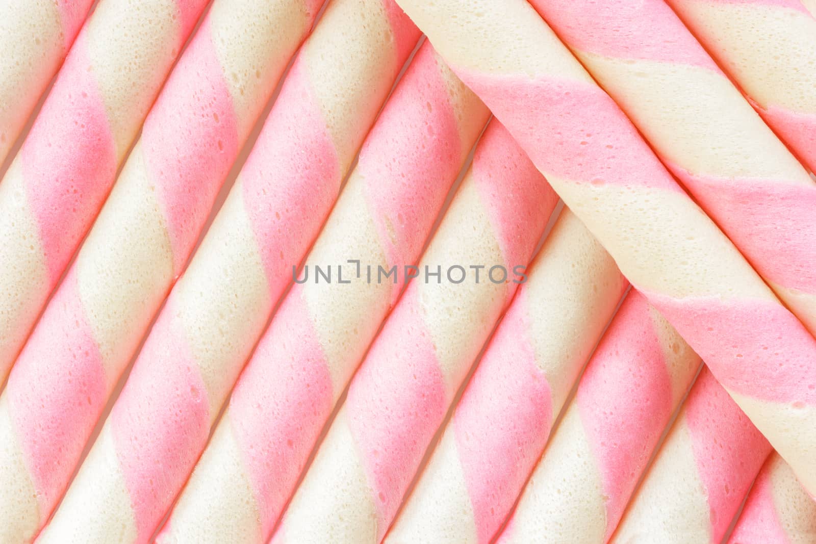 Closeup pink stripe wafer rolls Background .