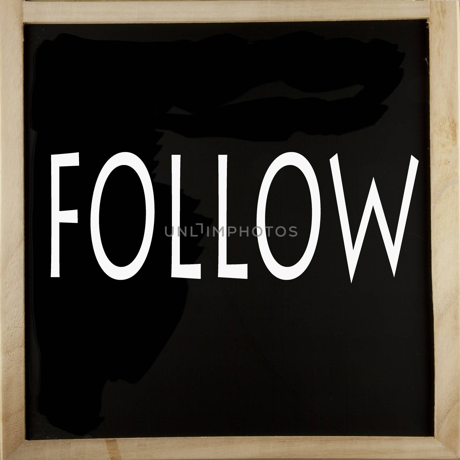 Word "Follow" written with chalk over a blackboard