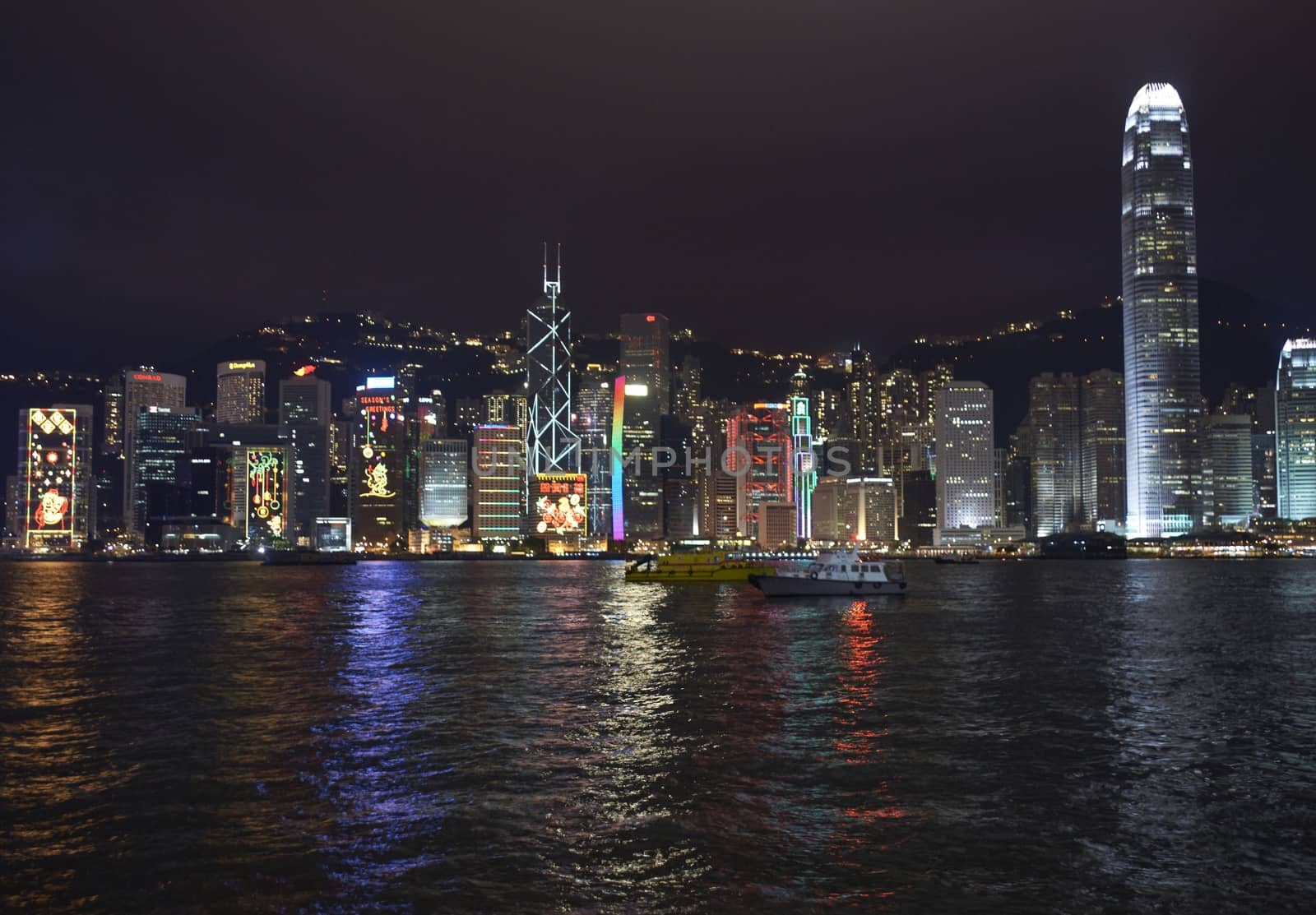 Illuminated office buildings lining the edge of Victoria Harbour in Hong Kong