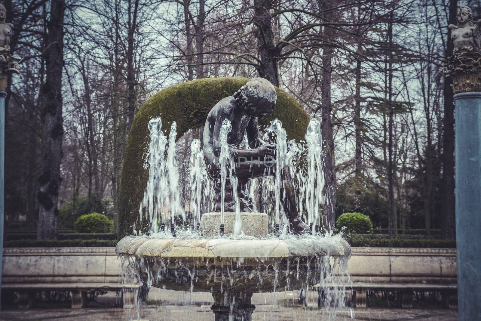 Ornamental fountains of the Palace of Aranjuez, Madrid, Spain.Wo by FernandoCortes