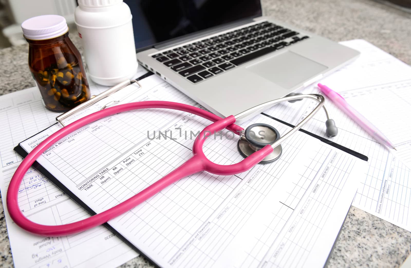 stethoscope and labtop and other medical object on the table