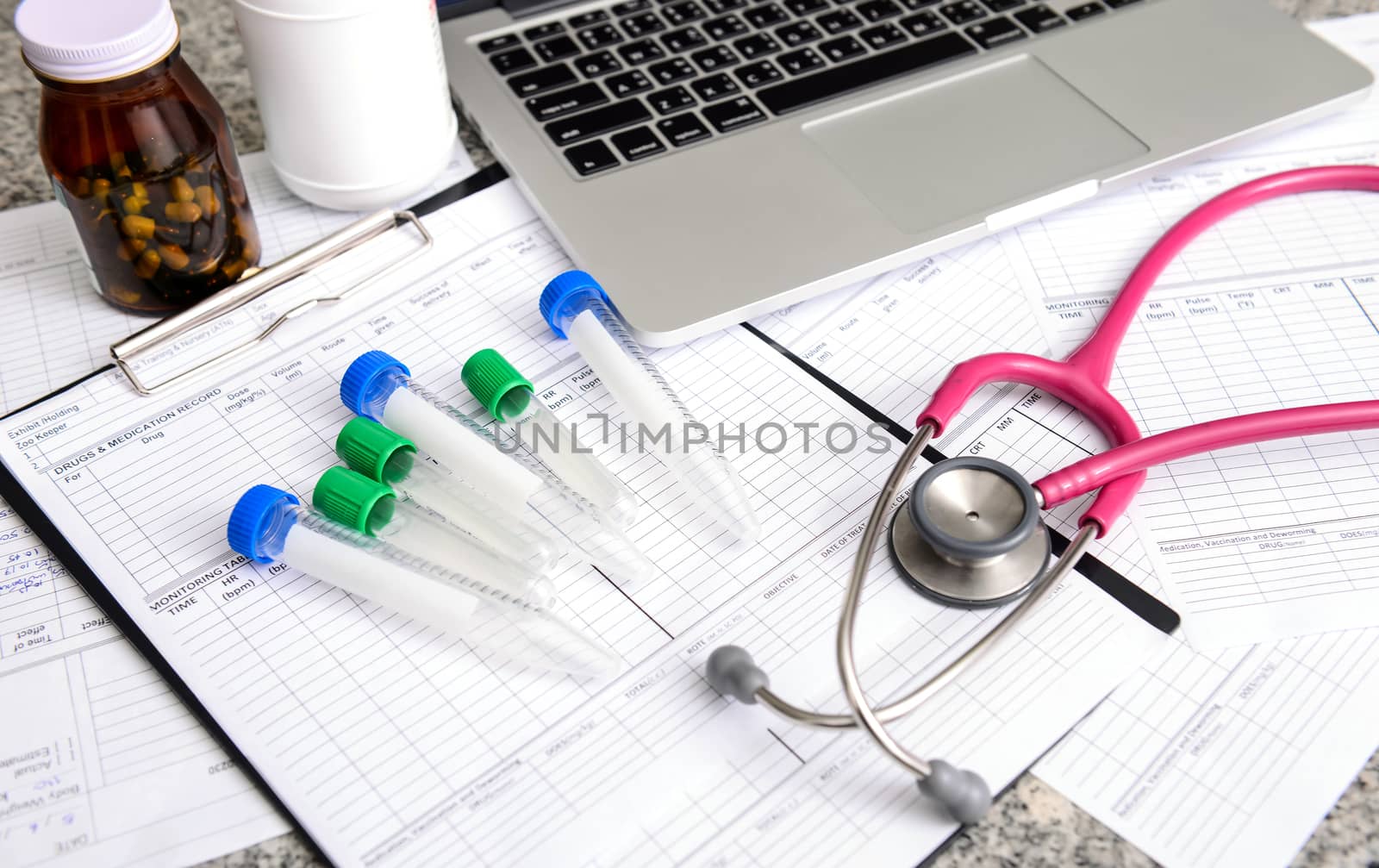 stethoscope and labtop and other medical object on the table