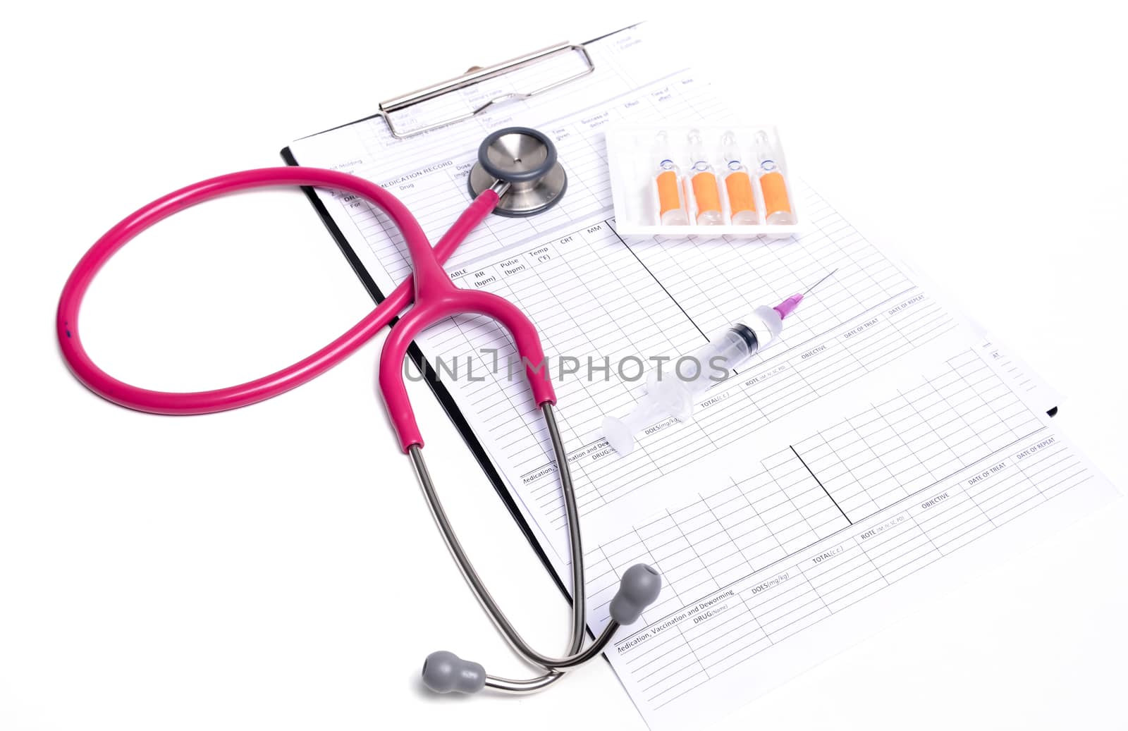 ampule syringe and stethoscope on white table
