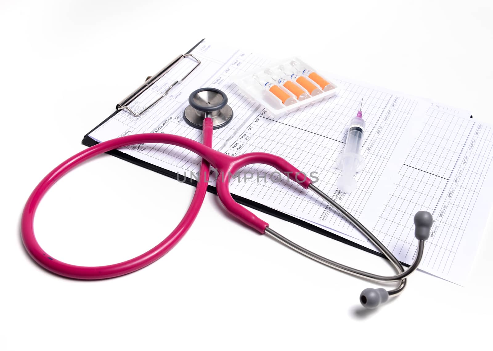 ampule syringe and stethoscope on white table