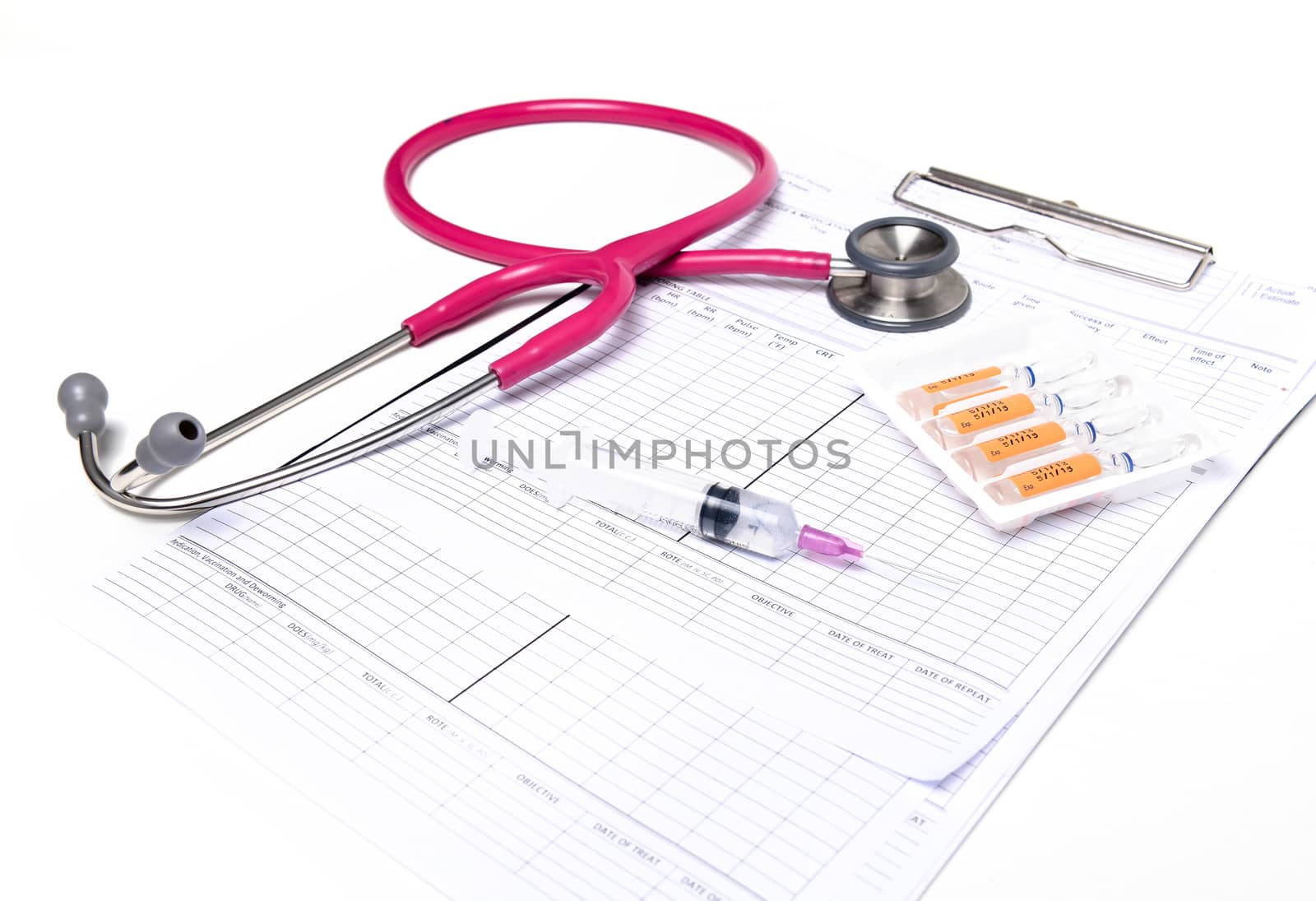 ampule syringe and stethoscope on white table