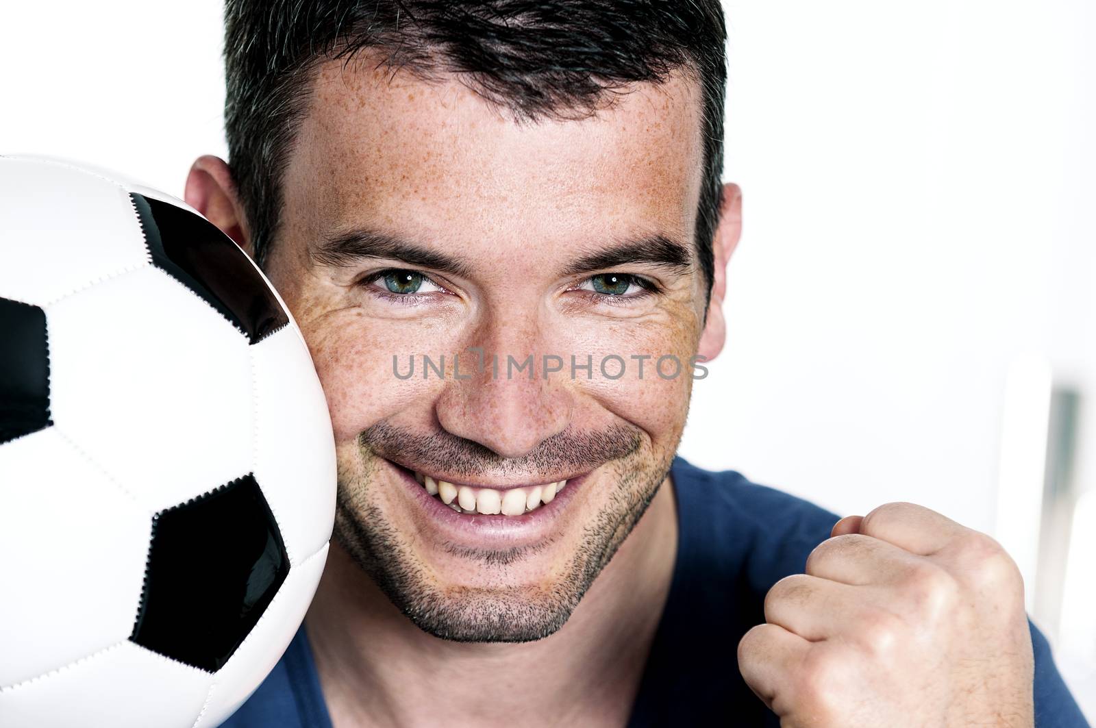 closeup of passionate soccer player with white and black balloon