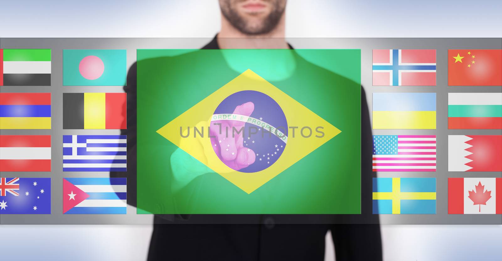 Hand pushing on a touch screen interface, choosing language or country, Brazil