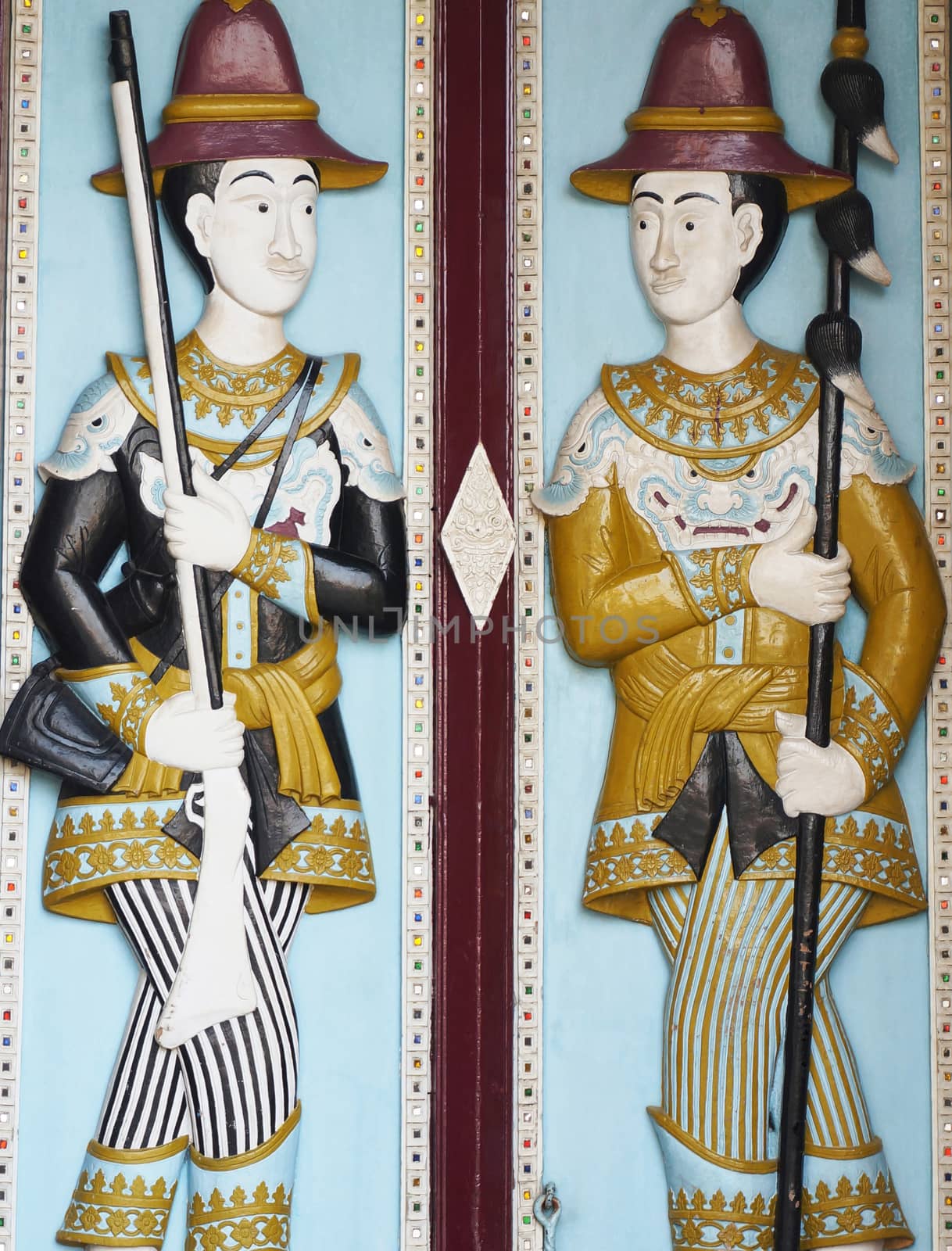 Thai military dressed in ancient military, hold the weapons in their hand. Draw a picture embossed on the wooden door.                         