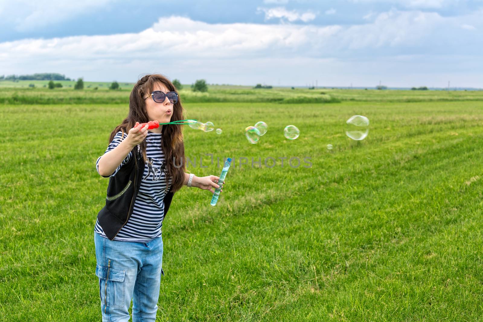 Beautiful Young Woman make Blowing Bubbles by Discovod