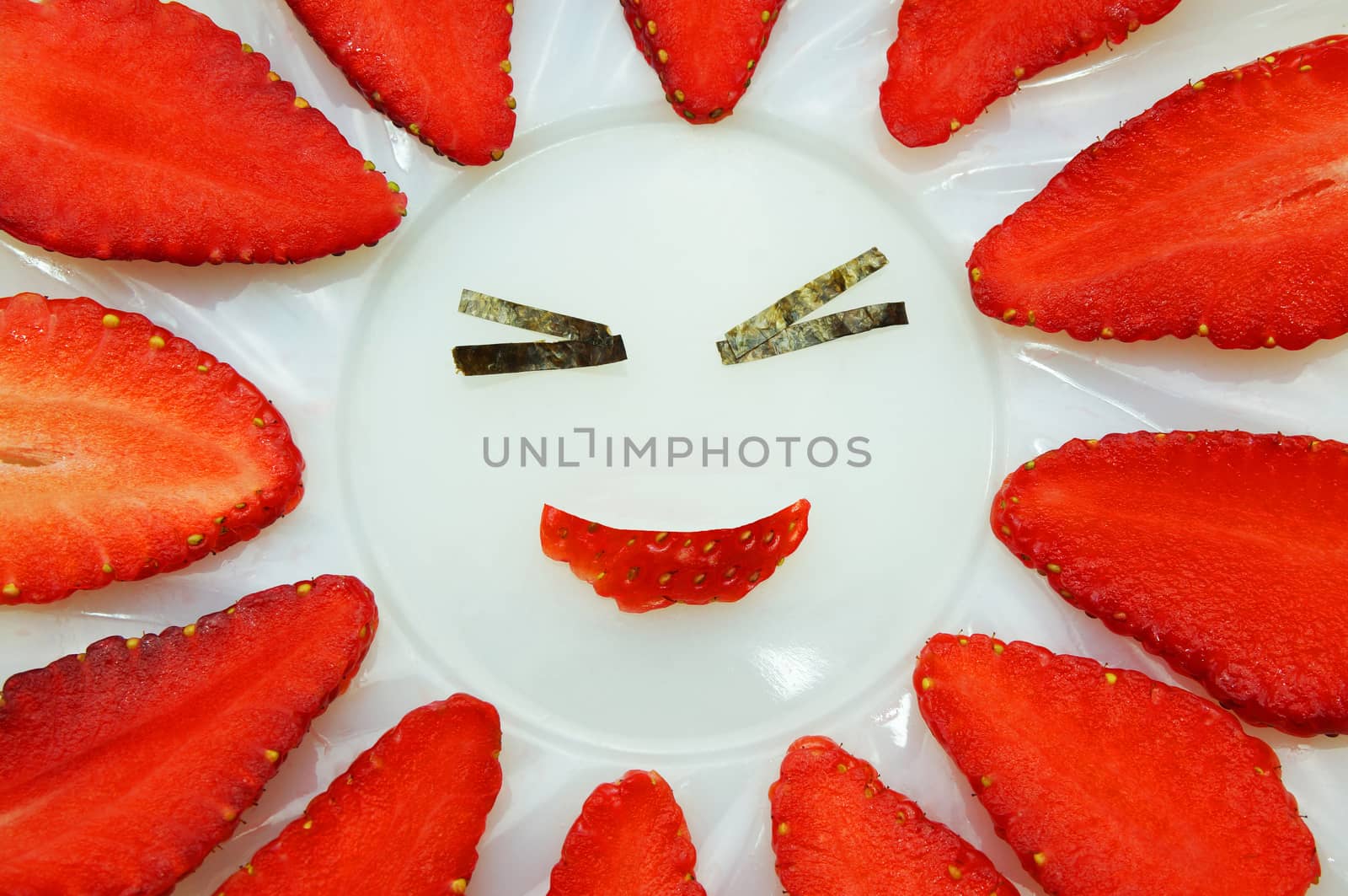 Strawberry, red berry freshness. Were sliced into thin strips, arrange on a plate decorated like happy people smiling.