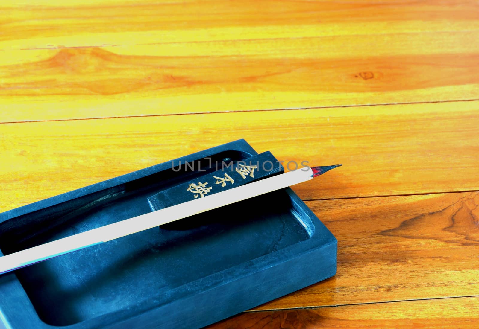 Inkstand, ink-stick and Brushes on wooden table by ninun