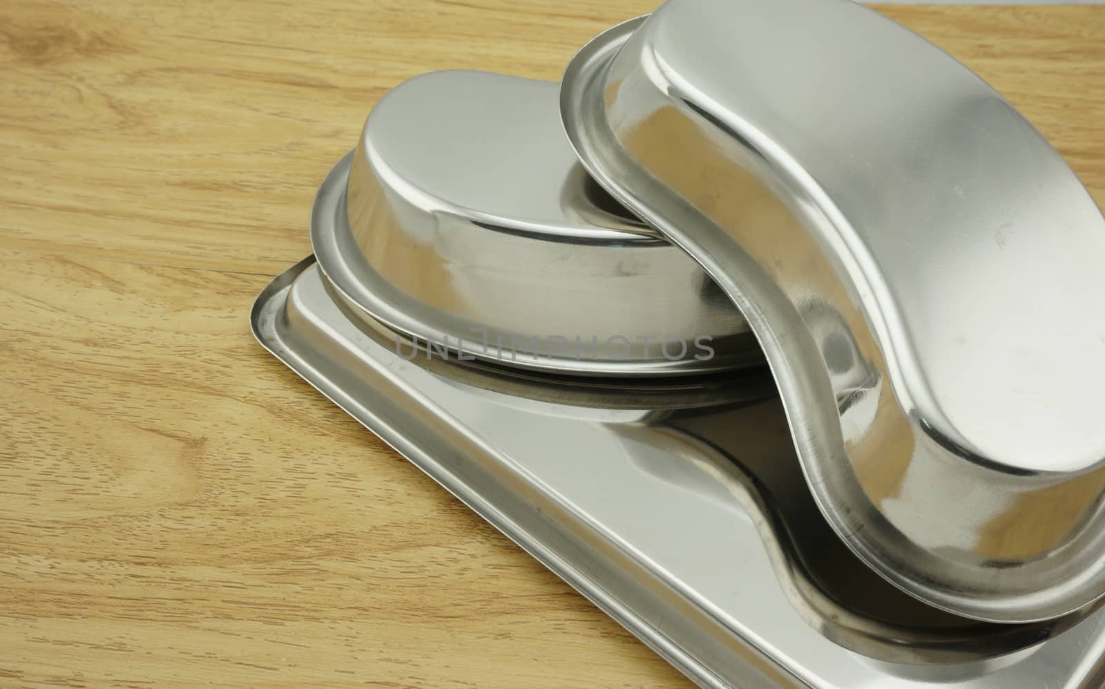 Two kidney-shaped bowl stainless steel drop two cards face down, stacked on a tray                              