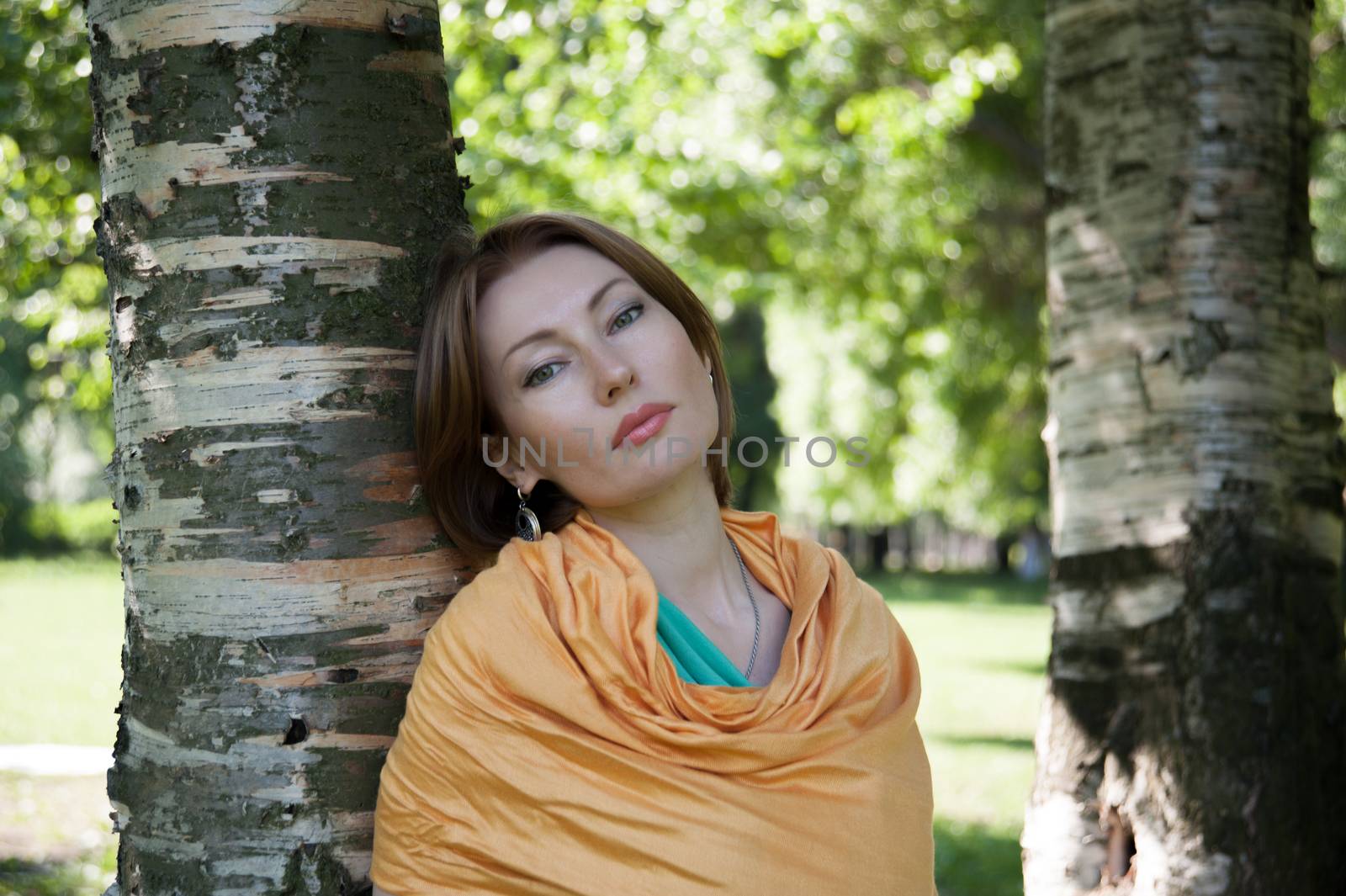 beautiful woman in birch summer in the Park for a walk