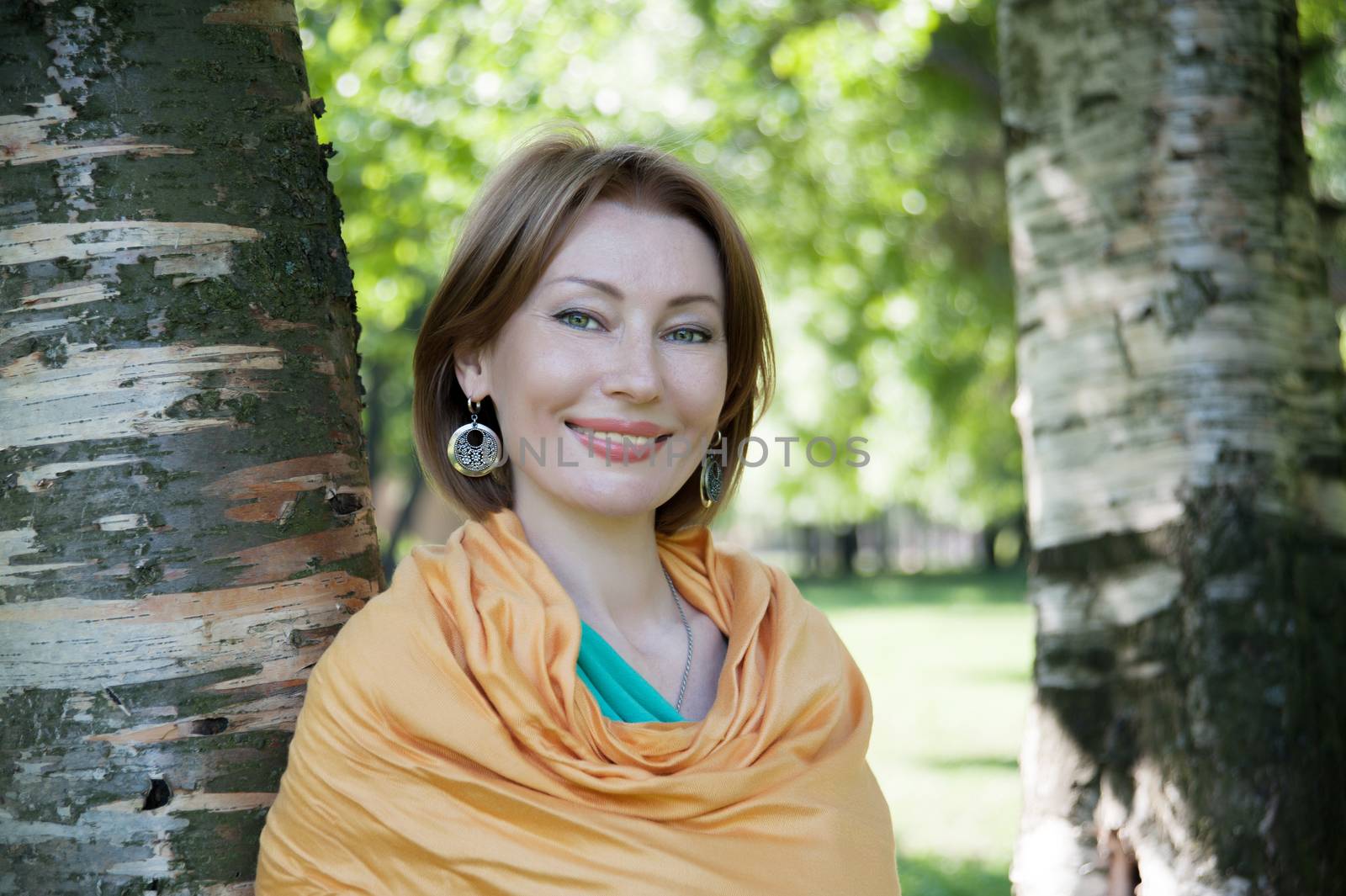 beautiful woman in birch summer in the Park for a walk