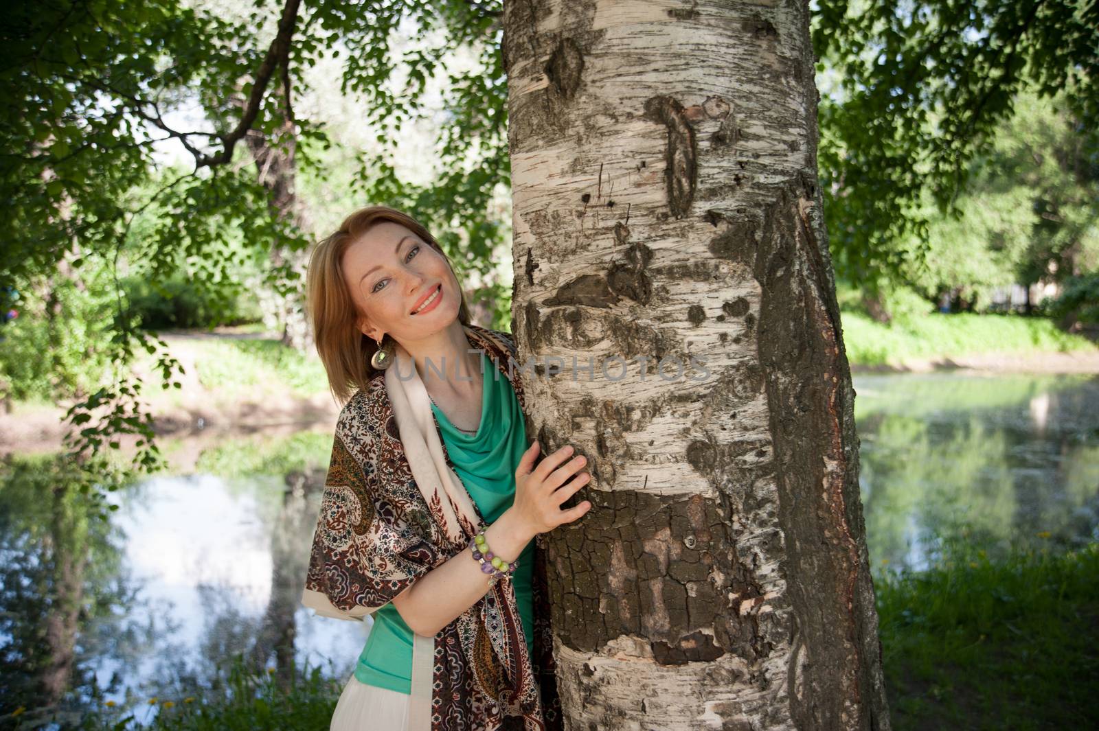 beautiful woman in birch summer in the Park for a walk