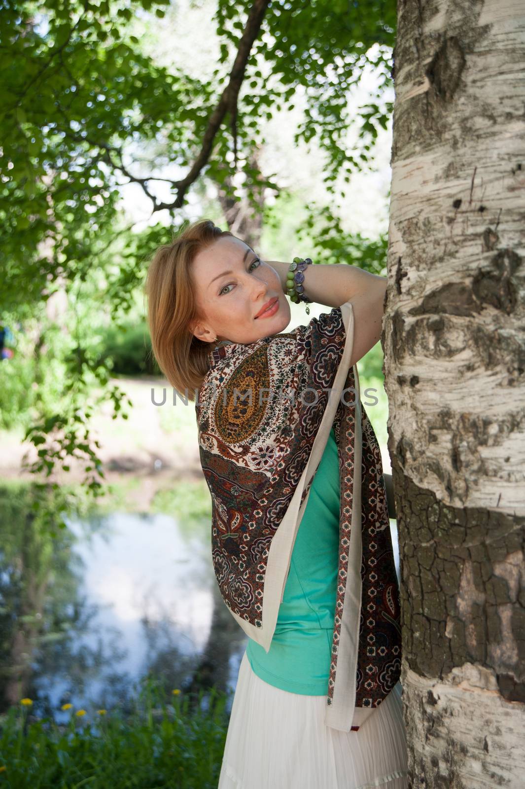 beautiful woman in birch summer in the Park for a walk