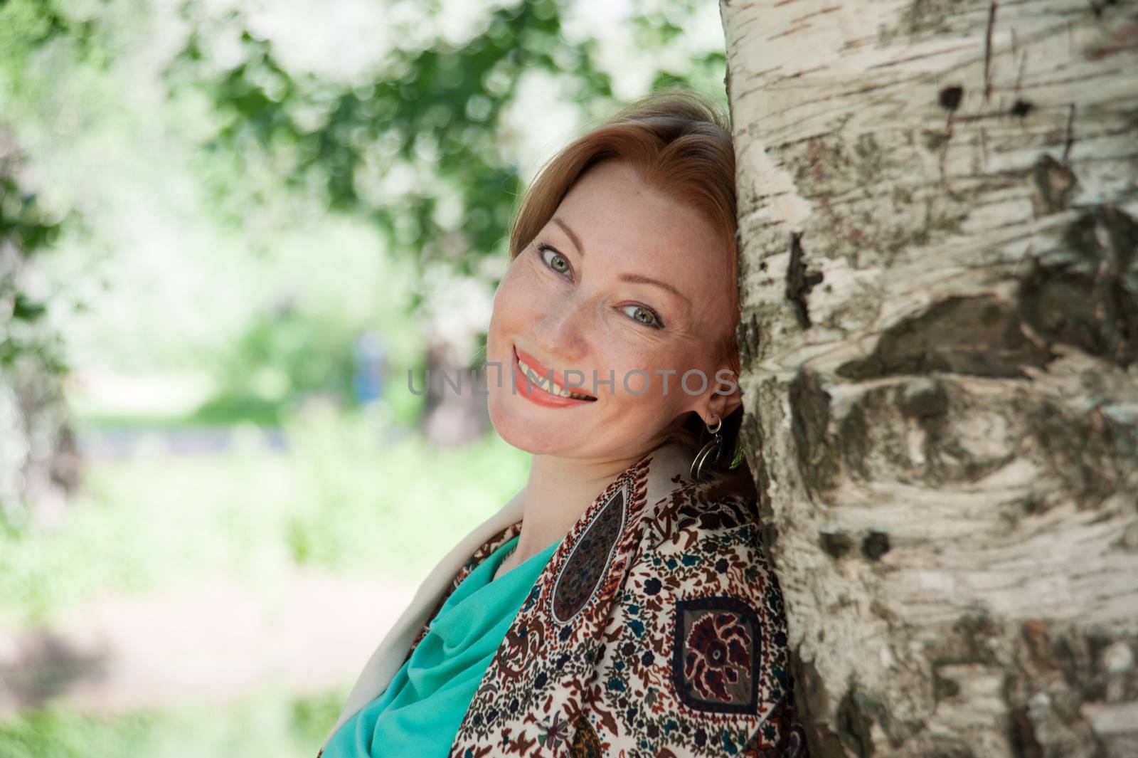 beautiful woman in birch summer in the Park for a walk