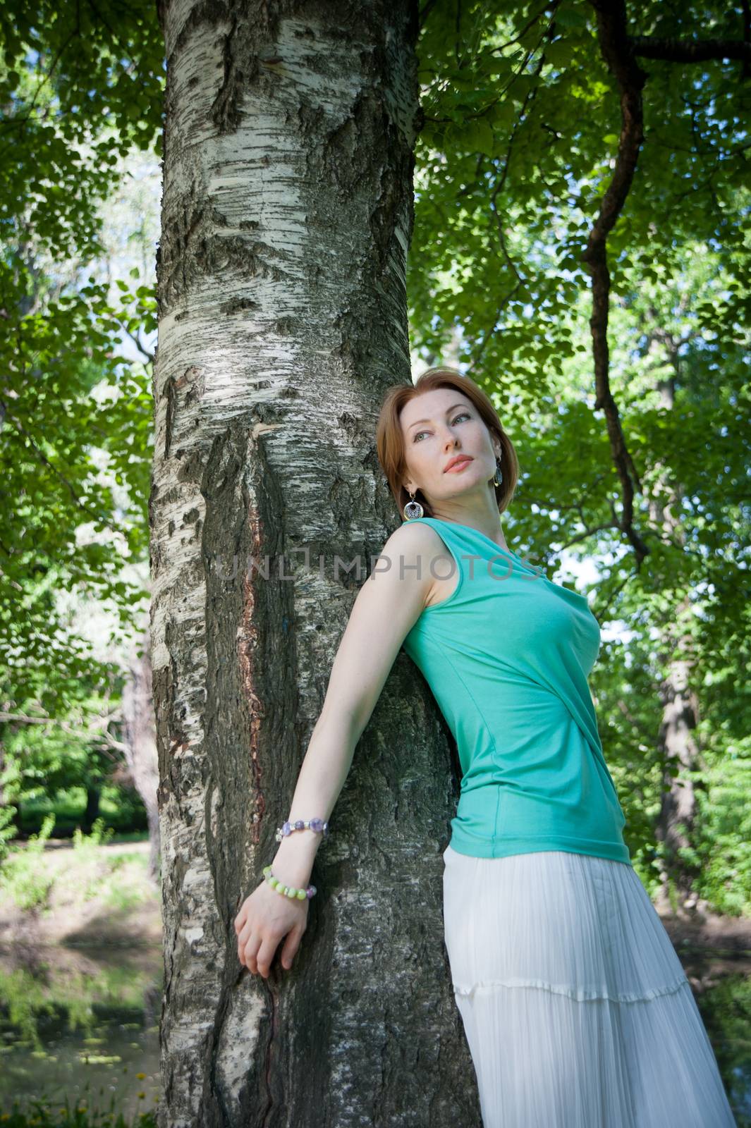 beautiful woman in birch summer in the Park for a walk