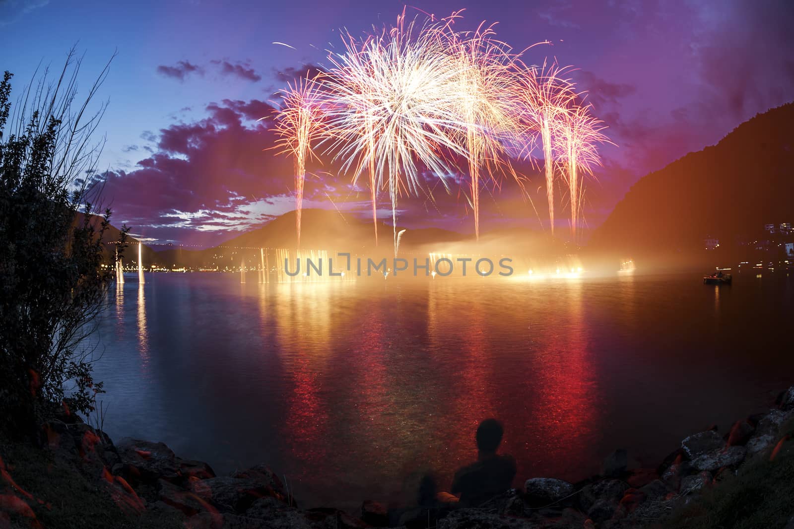 Fireworks on the Lugano Lake in a summer evening