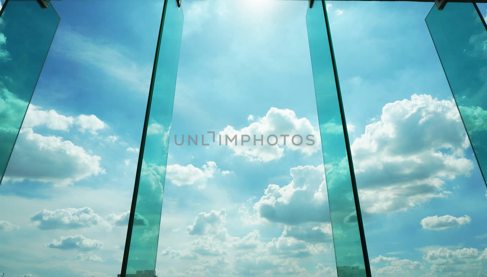 Glass window with reflection of clouds,  outside modern offifce building.                     