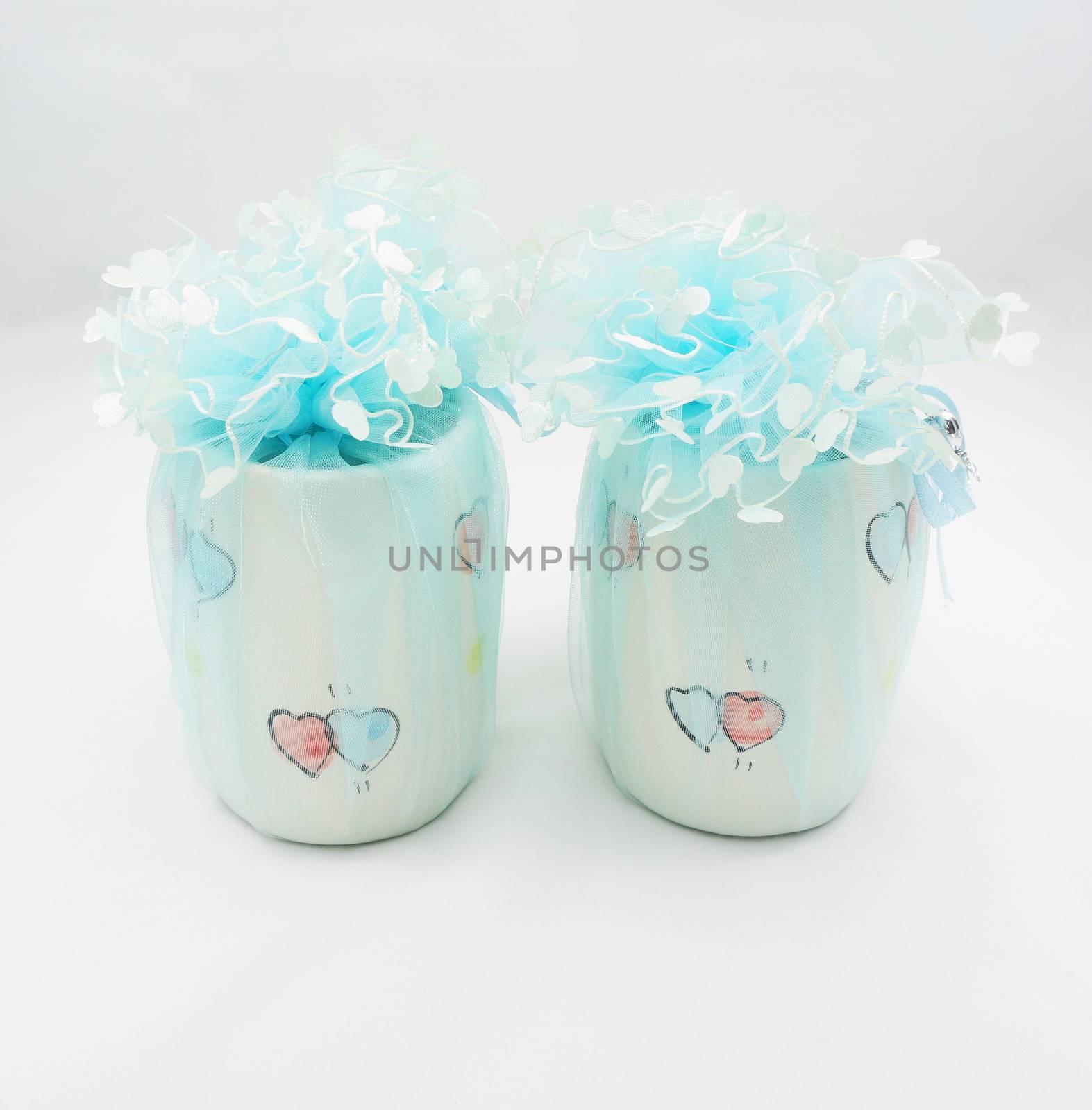 Souvenirs wedding day is a cup with a heart pattern, wrapped with blue mesh upper designed to tie into a heart-shaped mesh.                              