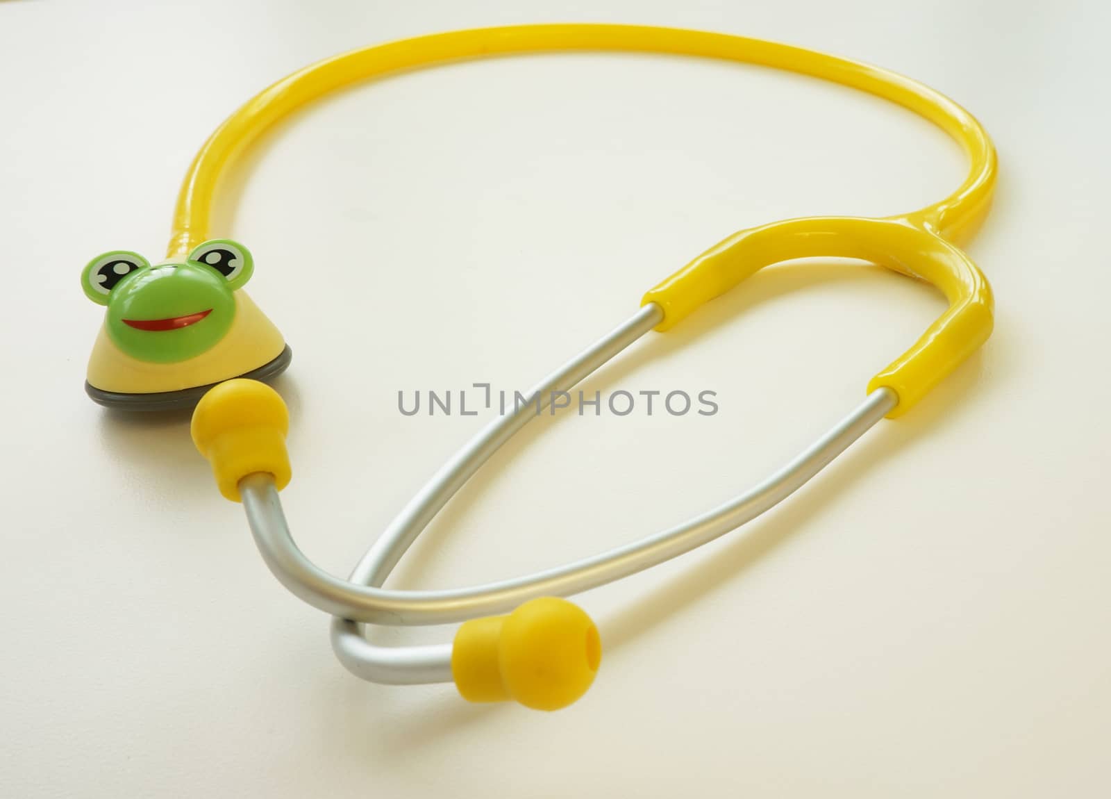 Bright yellow stethoscope prepared for patients who come to investigate. Placed on the table in the examination room.                               