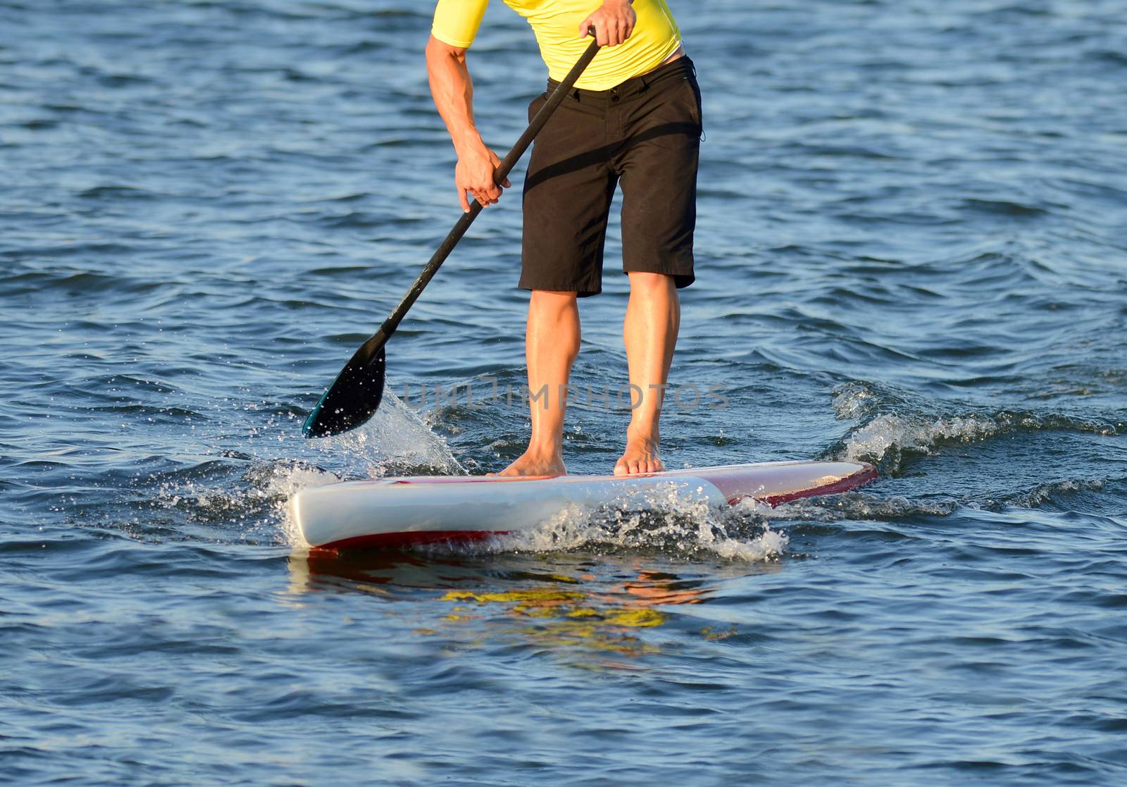 man on a paddle board in ocean by ftlaudgirl