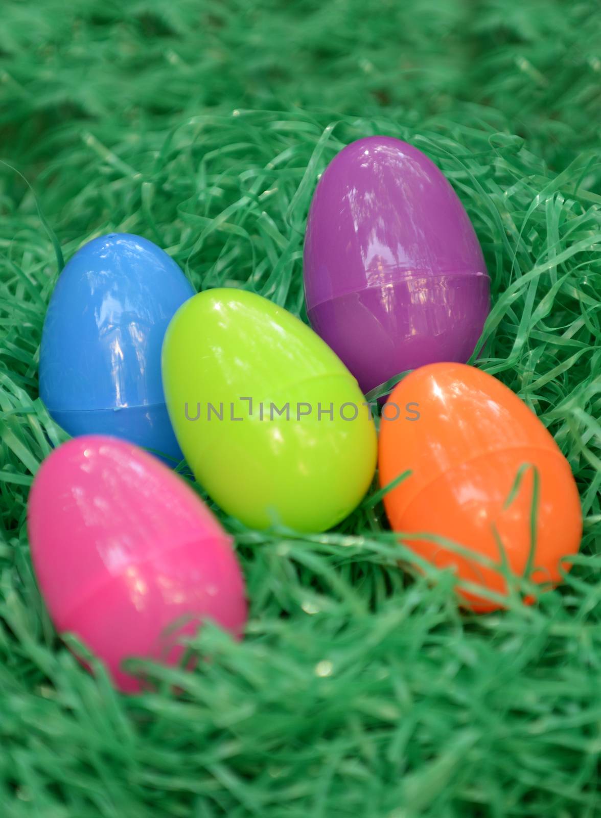 colorful plastic easter eggs in green grass
