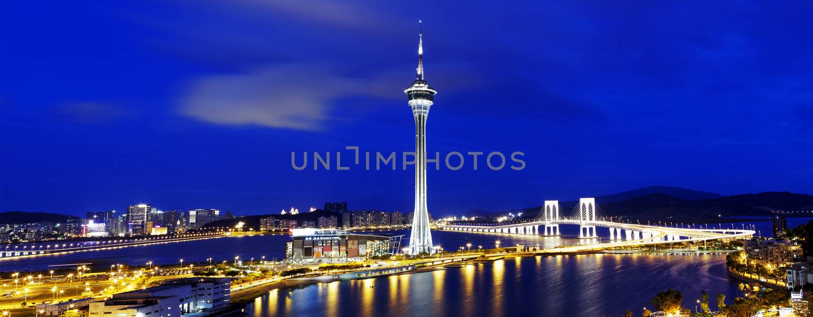 Urban landscape of Macau with famous traveling tower under blue sky near river in Macao, Asia. 