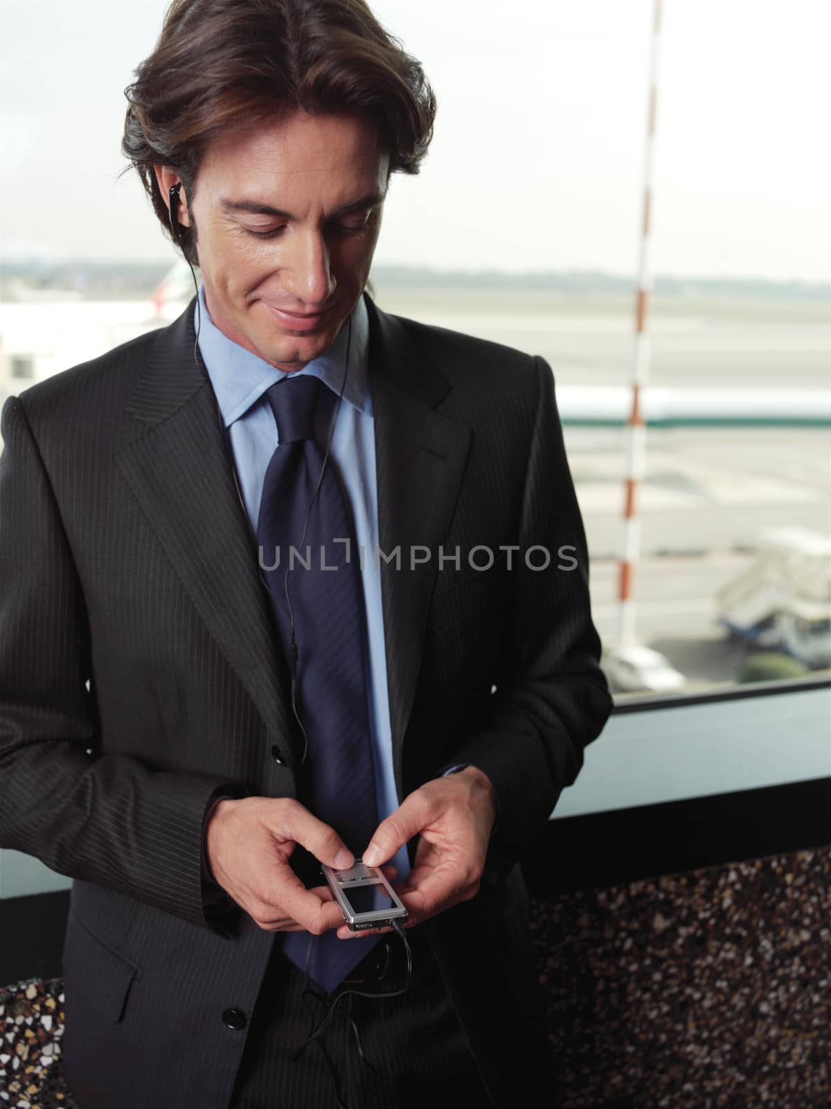 handsome young guy listening to favorite songs on the mp3 player 