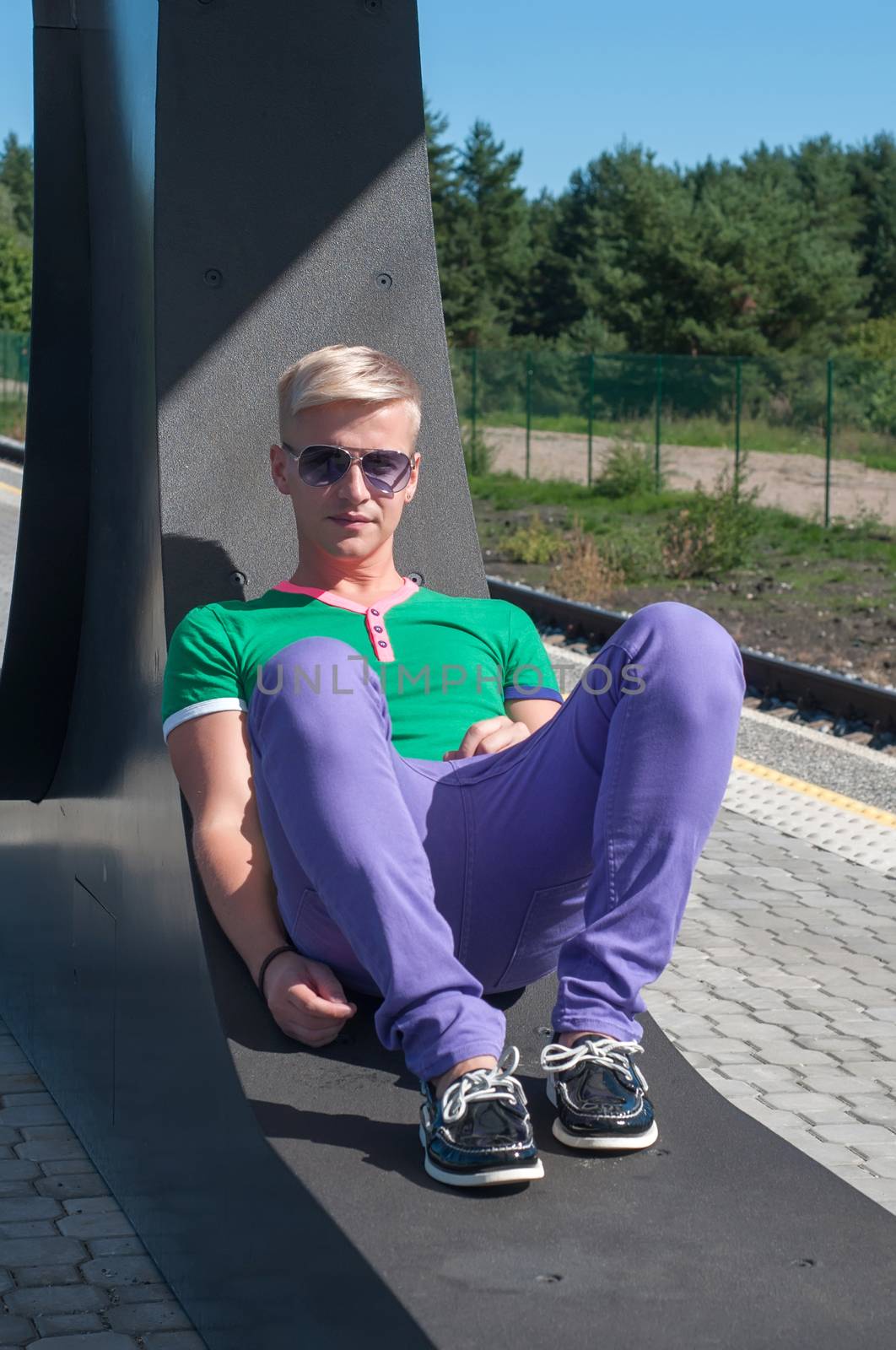 Handsome blond man sitting on the seat