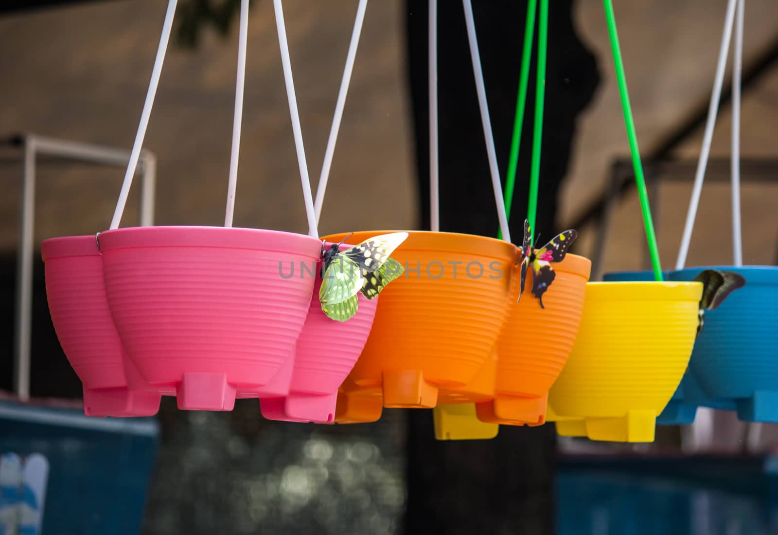colourful plastic flower pots by redthirteen
