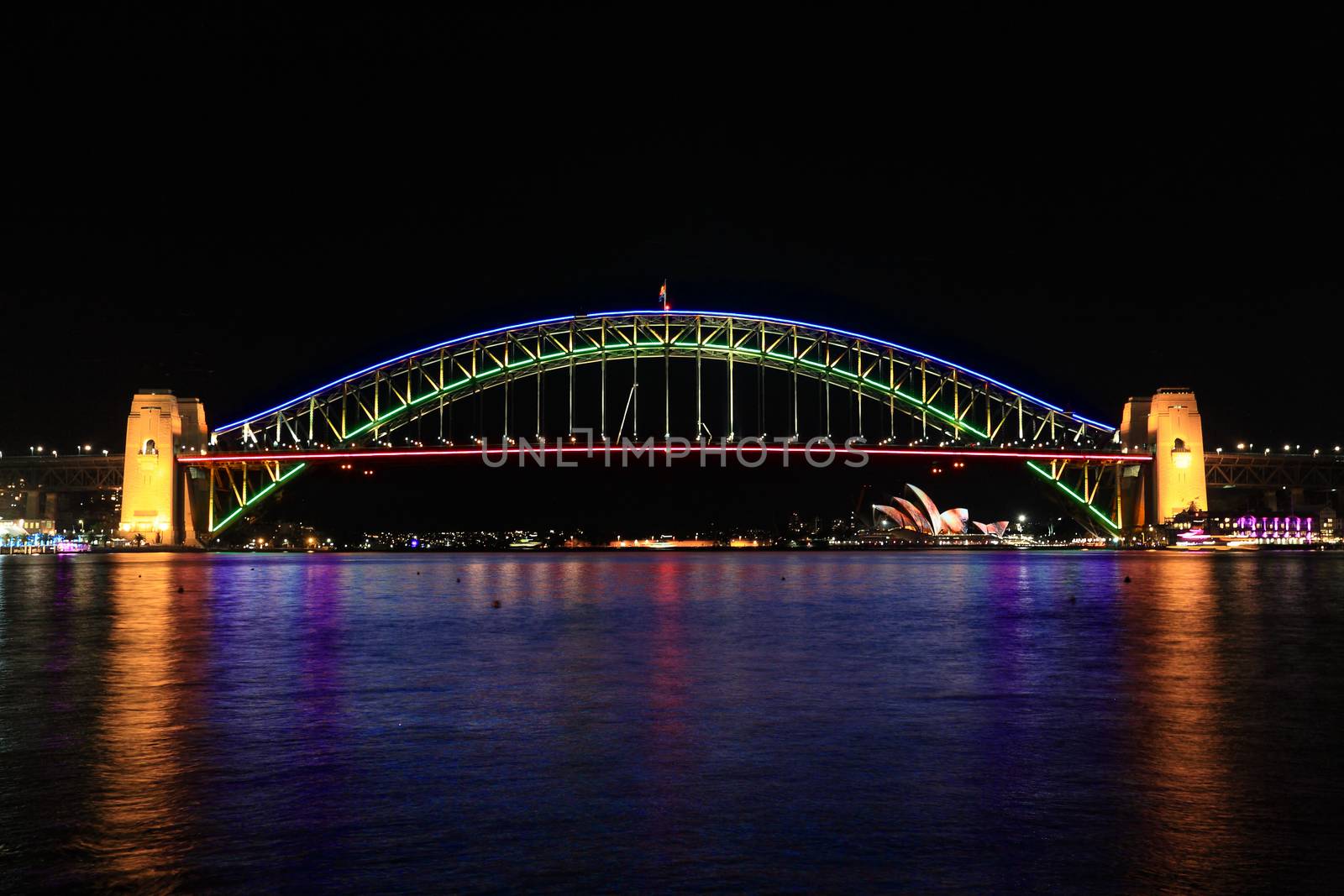 SYDNEY, AUSTRALIA - JUNE 2, 2014; The Sydney Harbour Bridge glows in a spectrum of beautiful colours during Vivid Annual Festival event