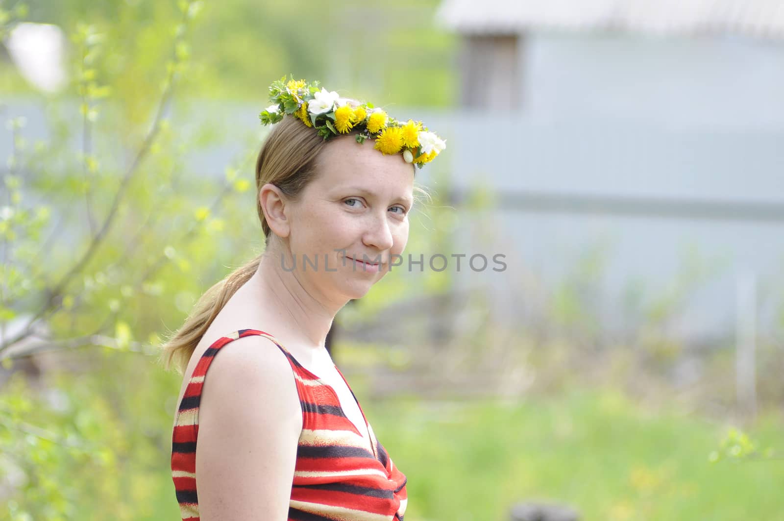 portrait of the happy woman with a wreath on the head