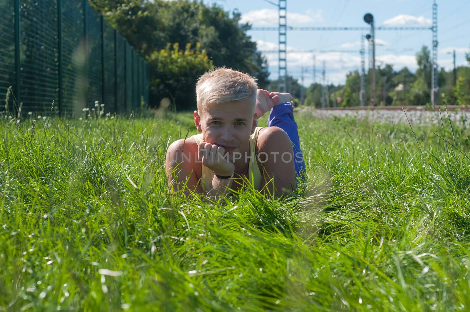 Handsome young man on the grass by anytka
