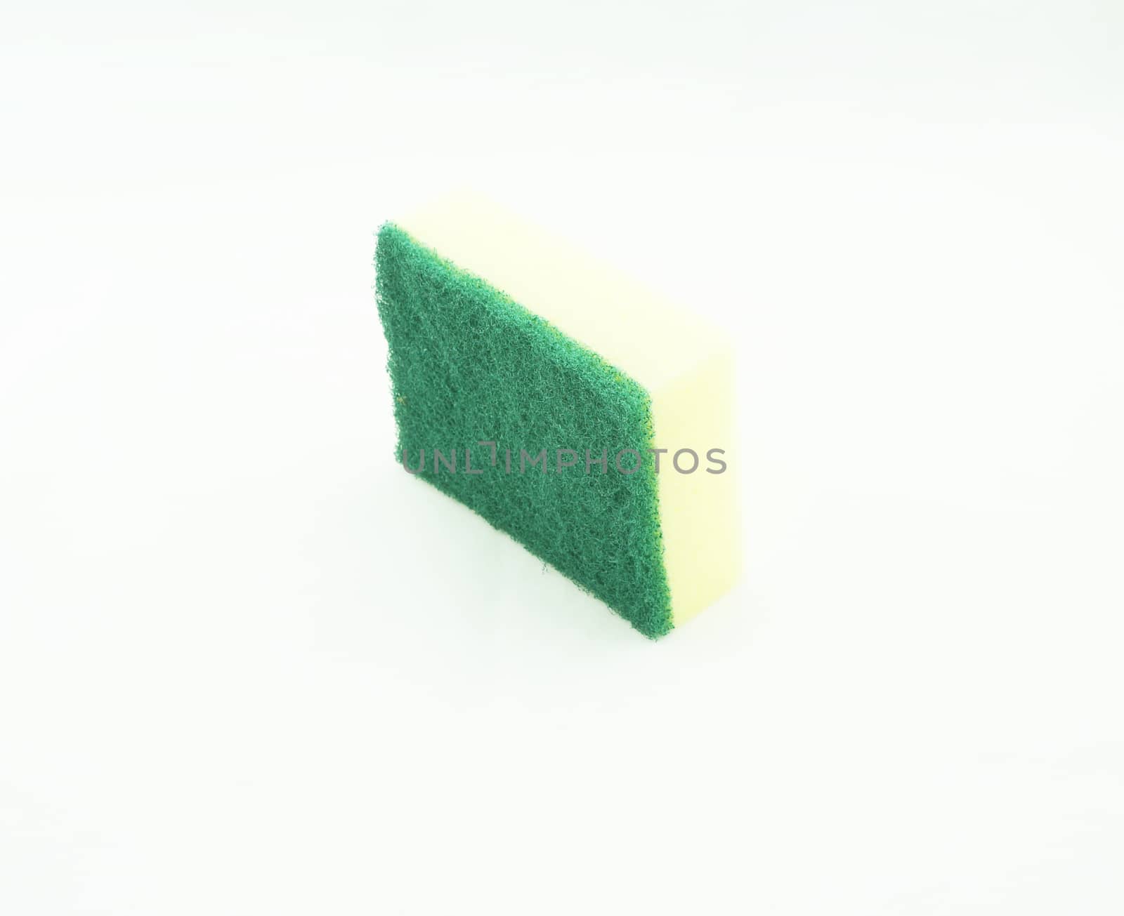 Dishwashing sponge has two sides, one rough green. another side is a yellow sponge.                               