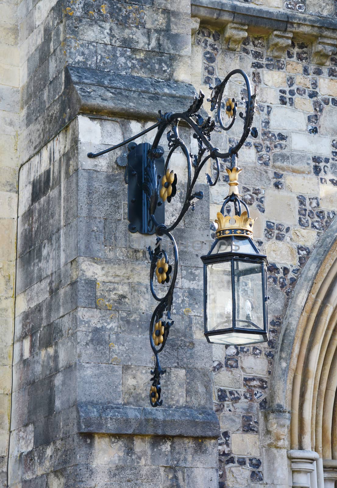 An ornate lantern on the stone exterior of the Great Hall in Winchester, England